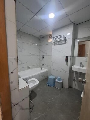 Un baño moderno con bañera, inodoro y lavamanos.