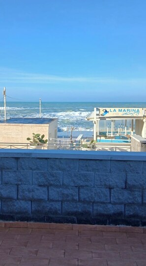 A coastal view with a building labeled "LA MARINA" featuring a pool and outdoor seating. - Lo scoglietto Apartment, 20 m from the sea (Rosignano Solvay)