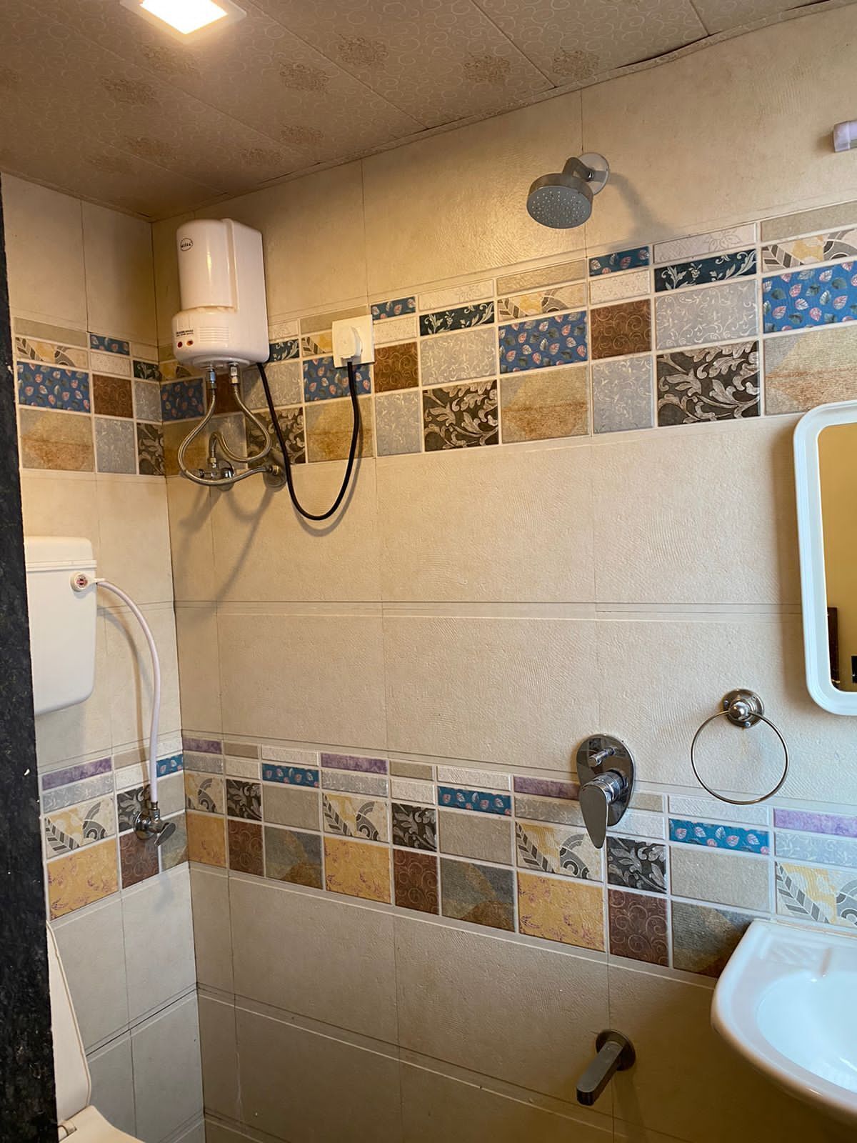 A bathroom with a shower, toilet, and sink.