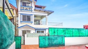 A multi-story residential building with a flat roof, a balcony on the upper floor, and a gated entrance. - Villa Bliss by Palette Homes (Mawal)