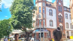 A historic building with a prominent tower and arched windows. - La Casa de Magdasa 3 (Warsaw)