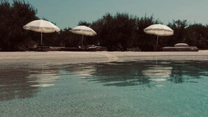 A clear pool with three white umbrellas, surrounded by trees. - Domaine FINCA LESSYA & SPA, Elegant lodge with pool view (Mauguio)