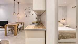 A modern kitchen with a wooden countertop, a sink, and pendant lights. - Vacation Home 'Ester & David' with Wi-Fi and Air Conditioning (Palamós)