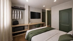 A modern hotel room with a bed, a desk, a TV, and a wardrobe. - Hospedium GL Hotel Andújar (Andújar)