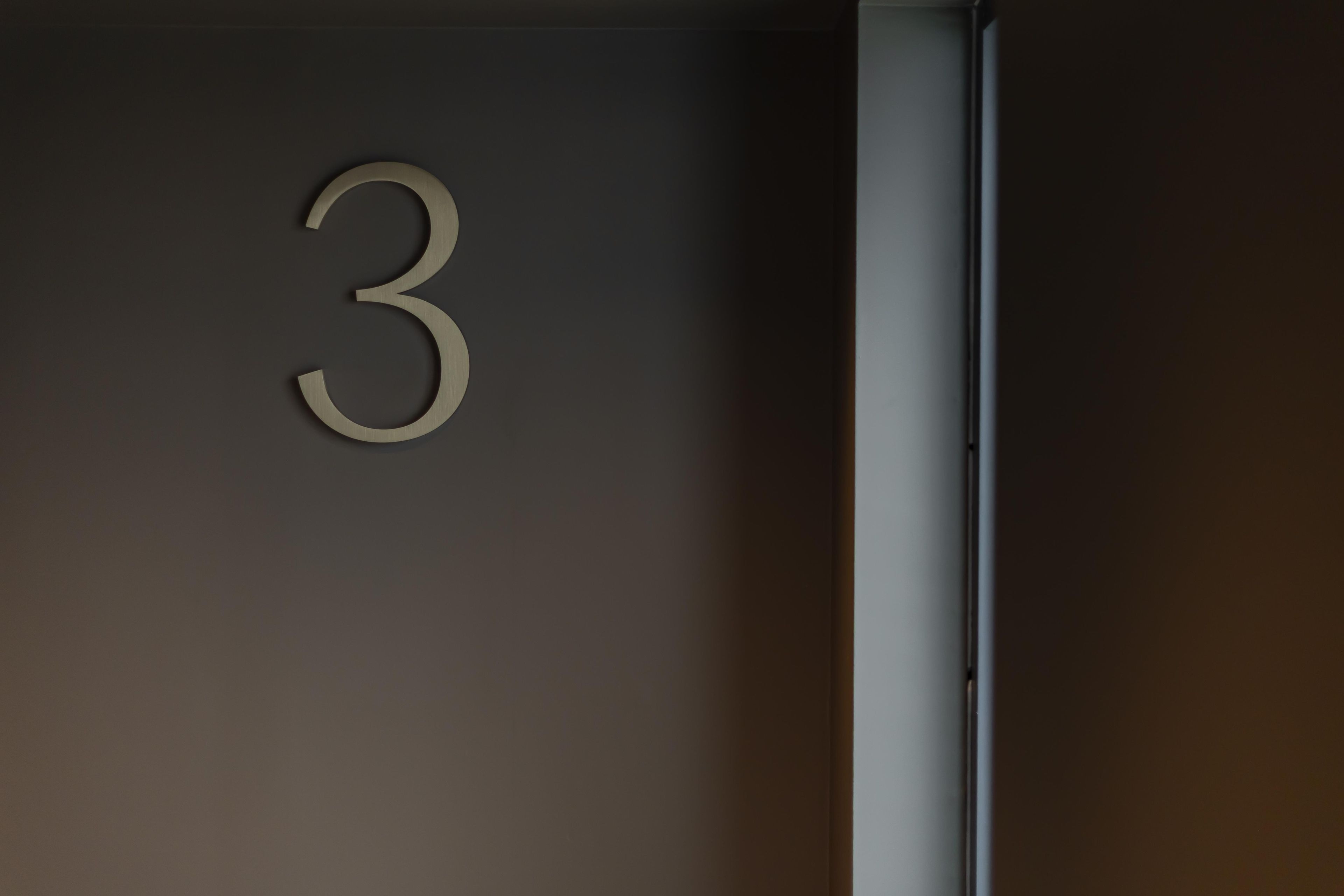 A wall with a large, three-dimensional number '3' indicating a room or section number.