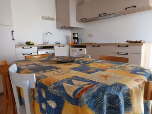 A compact kitchen with white cabinets, a coffee maker, and a microwave. - Bright 45m² Apartment in Notre-Dame-de-Monts - Pet Friendly (Notre-Dame-de-Monts)
