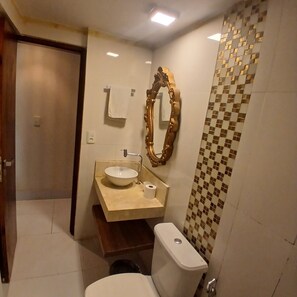 Ein Badezimmer mit Toilette, Waschbecken und Spiegel.