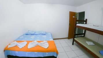 A small, single-bed room with a bunk bed against the wall, a tiled floor, and a door with a number sign.