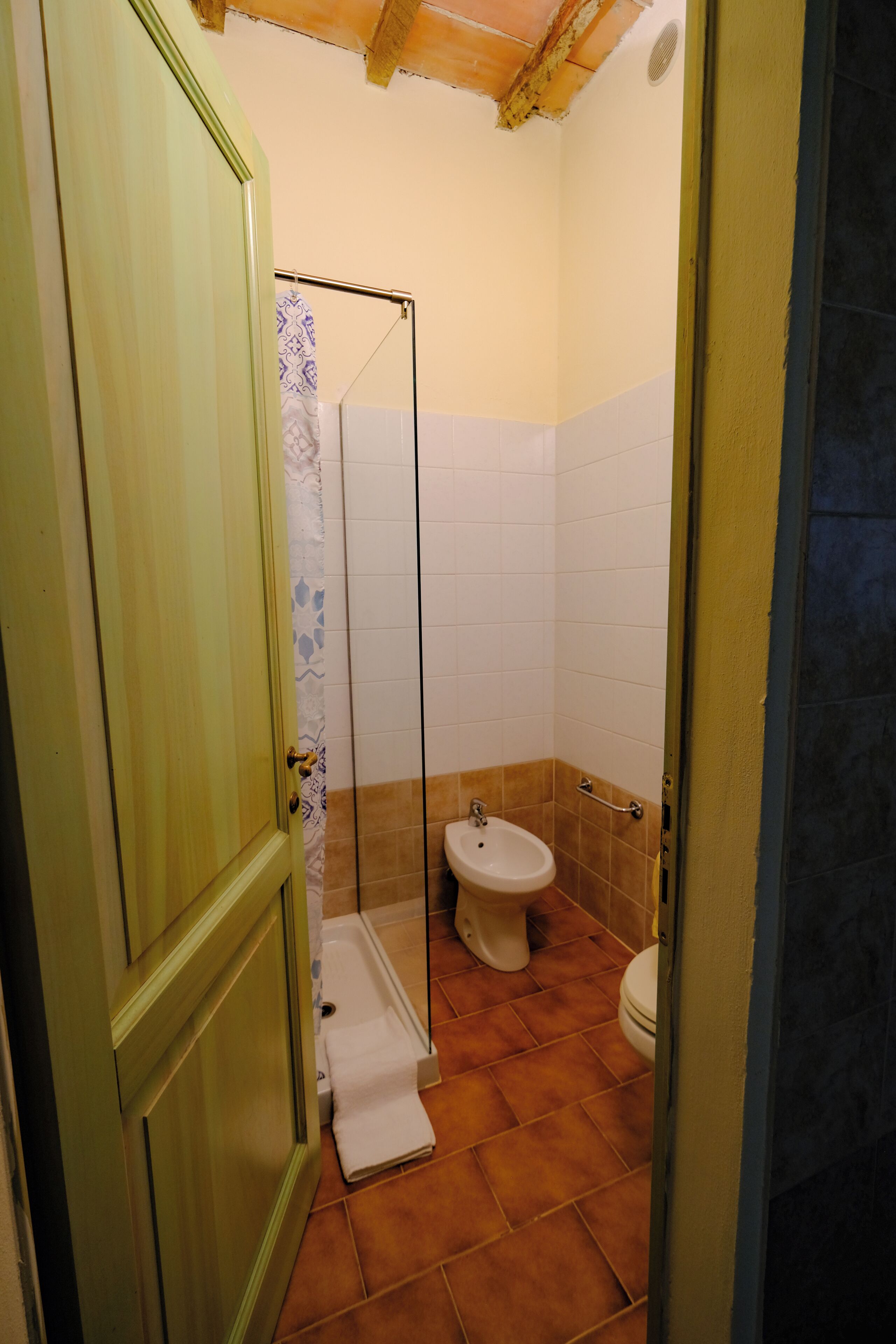 A bathroom with a shower, toilet, and sink.