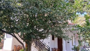 A white building with a staircase leading to a covered porch area. - Unawatuna Heritage Villas (Unawatuna)