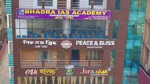 Un immeuble à plusieurs étages abritant divers commerces, notamment « The Katayani », « Bhadra IAS Academy », « Peace & Bliss Guest House » et « Jora Ilish ».
