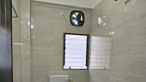 Une salle de bain avec des toilettes, une douche et un lavabo.
