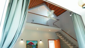 A staircase with white railings and wooden steps leading to a balcony. - We We Wayanad- Casa de Wayanad (Sulthan Bathery)