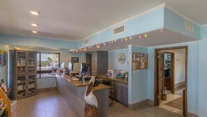 A kitchen with a central island, a refrigerator, and a window with blinds. - Tiki 157- Standard 1br Condo With Large Balcony 1 Bedroom Condo (South Padre Island)