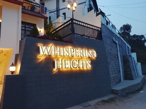 A building with a sign that reads 'Whispering Heights.' - whispering heights (Kasauli)
