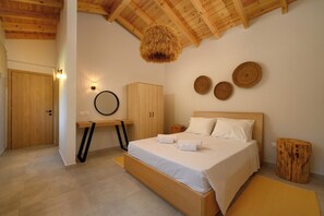 A bedroom with a wooden bed, a round hanging light, a wooden wardrobe, and a round mirror on the wall. - The Aeolina Collection Villas - Villa Natalia (Corfu)