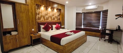 A modern bedroom with a wooden bed, a nightstand, a wardrobe, and a desk with a chair.