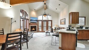A spacious kitchen with wooden cabinets, a large island, and a fireplace. - Marina Park Mountain View Townhome: Heart of Frisco (Frisco)