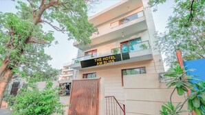 A multi-story hotel with balconies and a sign reading "The Hotel Am Bliss". - The Hotel Am Bliss (Gurugram)