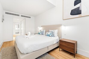 A modern bedroom with a bed, bedside table, and a wall-mounted artwork. - Unique Luxury and Quiet in Porto’s Best Location (Porto)