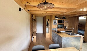 A compact kitchen with wooden cabinetry, a built-in microwave, and a sink. - T2 with pool in Saint-Gervais-les-Bains (Saint-Gervais-les-Bains)