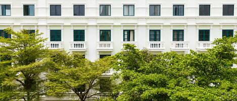 A multi-story building with a symmetrical facade, evenly spaced windows, and a central entrance.