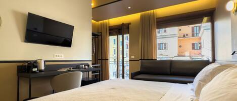 Deluxe Quadruple Room, Private Bathroom, City View | In-room safe, desk, laptop workspace, blackout drapes