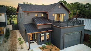 A modern two-story house with a garage, a covered patio, and a small garden area. - Mstr dwn! Pool, DiscGolf, ZipLine, FirePit (Canyon Lake)