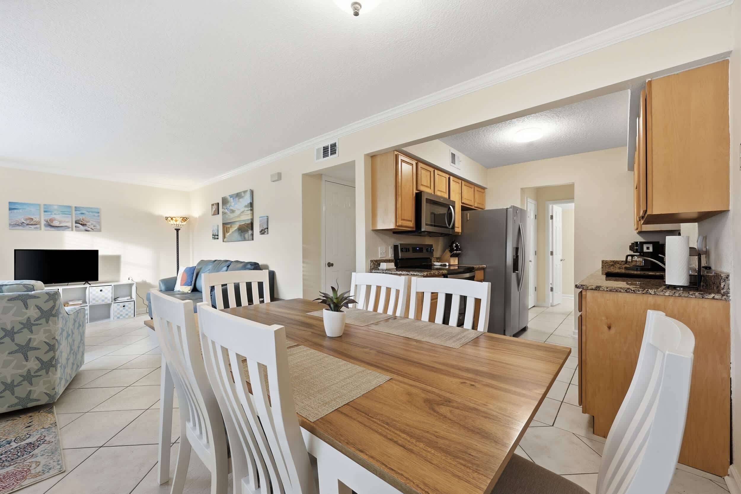 A modern kitchen with wooden cabinets, a microwave, and a refrigerator.