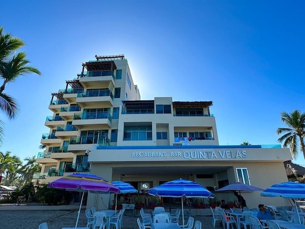 A multi-story building with a restaurant/bar named 'Quinta Velas' on the ground floor.