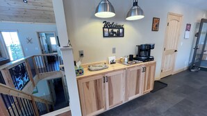 A modern kitchen with wooden cabinets, a coffee maker, and pendant lights. - Flying Goose - newly built 4-bedroom house with incredible views in Wilmington (Wilmington)