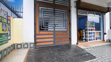 A clinic with a large wooden door and a tiled entrance.