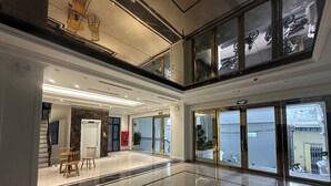 A spacious lobby with a polished marble floor, a staircase, and a view of the outside through large glass doors. - Atlantis Apartment Nguyen Xuan Khoat (Hanoi)