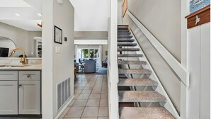 A modern kitchen with white cabinets, a stainless steel sink, and a wooden countertop. - Moneta Gem: Modern 3BR Townhome w/ Lake Access & Serene Views (Moneta)