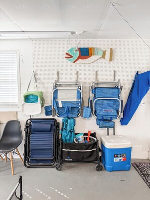 A room with a pegboard wall displaying various items, a blue cooler, a black suitcase, and a folding chair. - Forever Lane Retreat…
A Family Friendly Pool home in Sarasota (Sarasota)