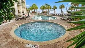 A swimming pool area with lounge chairs, palm trees, and a sign indicating a depth of 3 1/2 feet. - Breaker's Boutique Resort 1857- 2BR/2BA- Pool (Myrtle Beach)