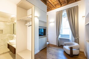 Ein modernes Badezimmer mit Marmorwaschbecken, einer Duschkabine aus Glas, einem integrierten Fernseher und einer Holzbeschichtung der Decke.