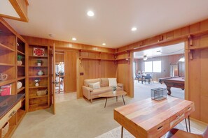 A spacious room with a wooden floor, a beige sofa, a wooden coffee table, and a pool table. - Panoramic Views Huge Deck Game Rm EV Charger (Rimforest)