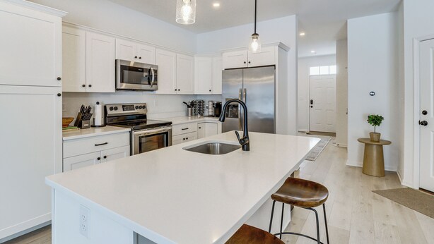 A modern kitchen with white cabinetry, stainless steel appliances, and pendant lighting. - Half-mi to the Triangle! Chic Emmaus Townhome (Emmaus)