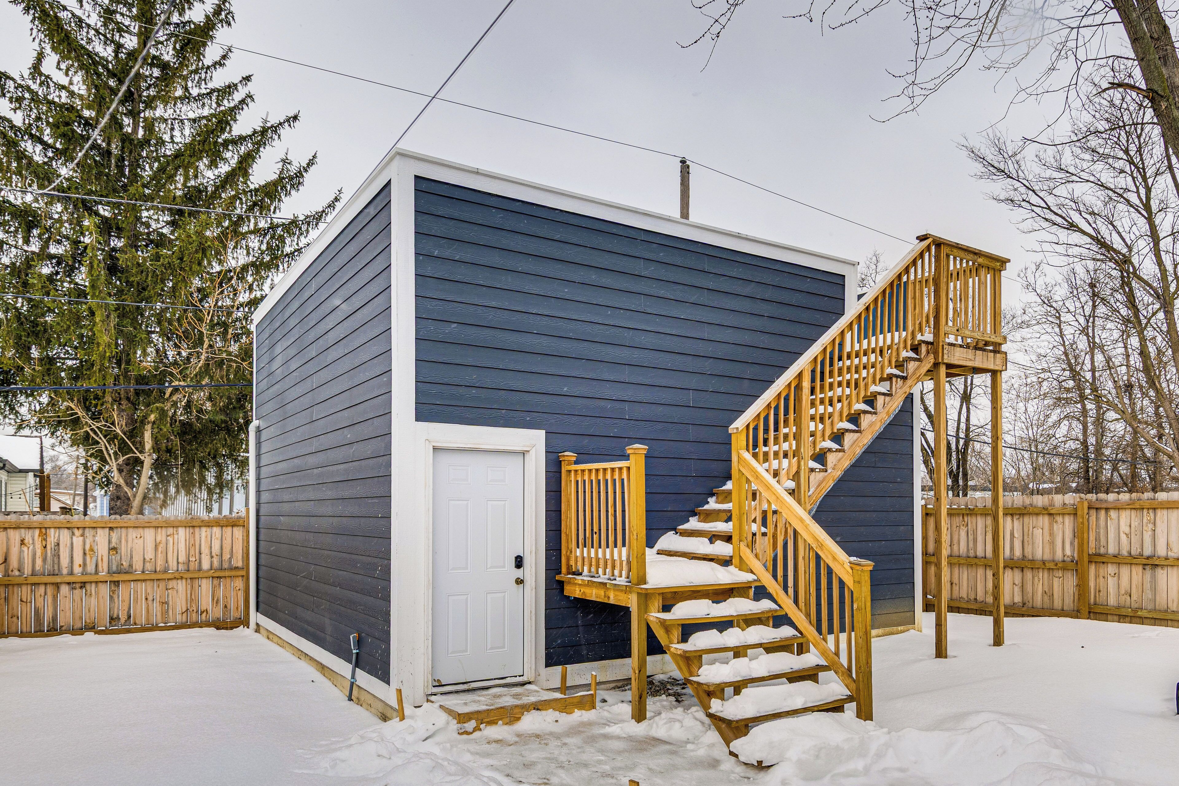 A single-story building with a wooden staircase leading to a door.