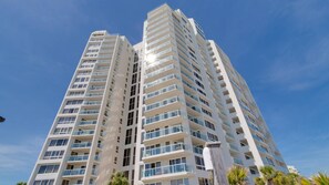 A high-rise building with multiple balconies, large windows, and a clear sky. - 🌴Stunning Beachfront Views | Pool | Beachside II #4260🌴 (Miramar Beach)