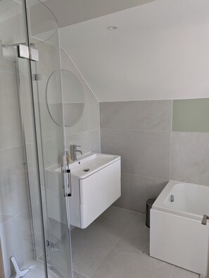 Shower, hair dryer, towels, toilet paper