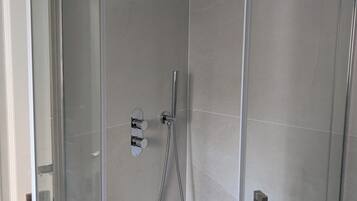 Shower, hair dryer, towels, toilet paper