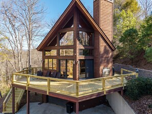 A cabin with a deck, large windows, and a chimney. - Pet-Friendly Home Near Vogel State Park (Blairsville)