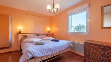 Tabla de planchar con plancha y ropa de cama