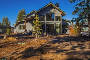 A modern two-story house with large windows and a covered patio. - Modern Caldera Retreat with Access to Exclusive Golf (Sunriver)