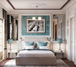 A bedroom with a large bed, two bedside tables, a ceiling light fixture, and a framed picture on the wall. - Villa Costanza Boutique Hotel (Forte dei Marmi)