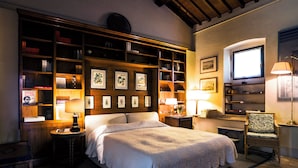A well-lit bedroom with a large bed, a wooden bookshelf, and a desk with a chair. - Cottage on the Chianti Hills-Il Borghetto (San Casciano In Val Di Pesa)