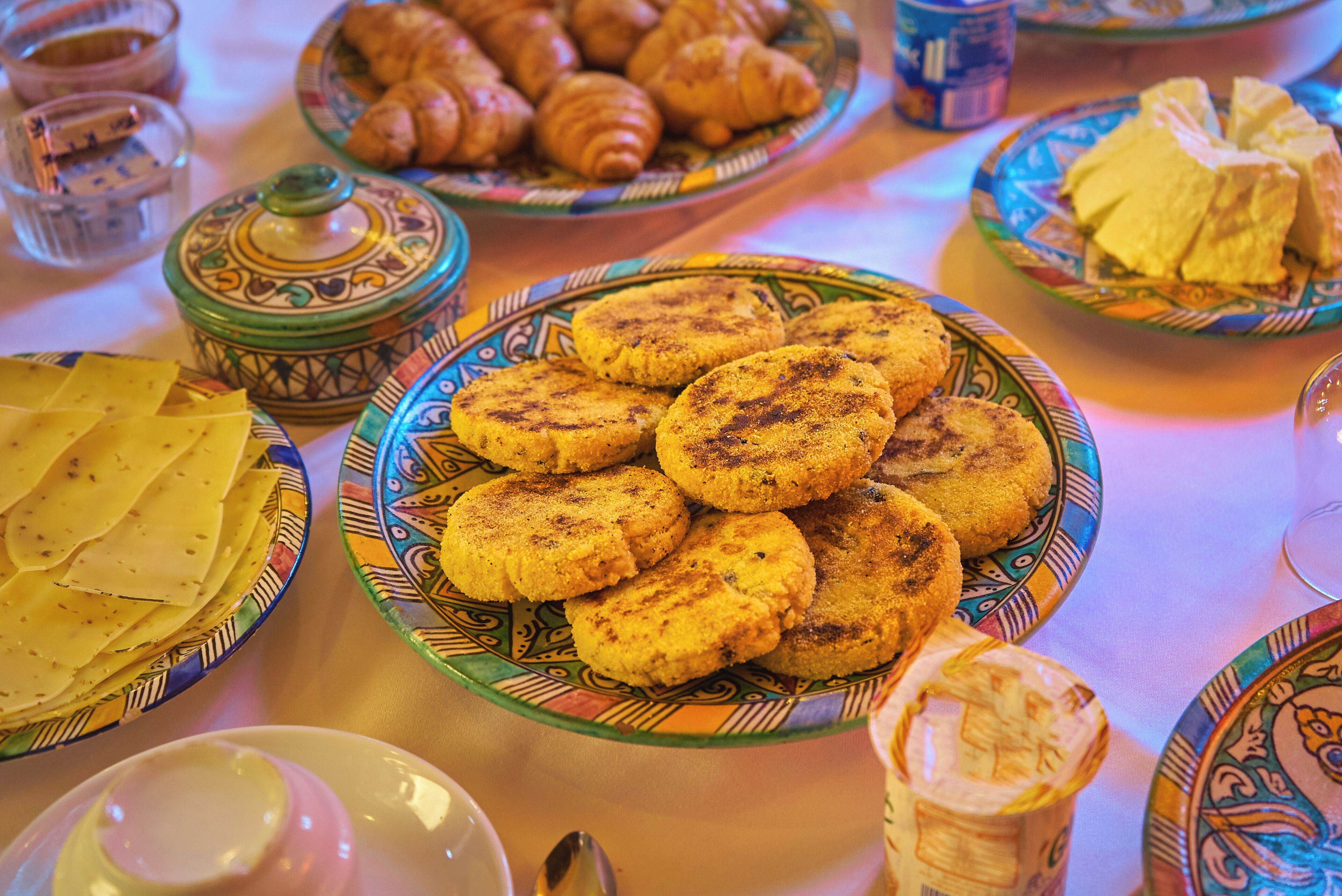 A table with various food items including pastries and bread.