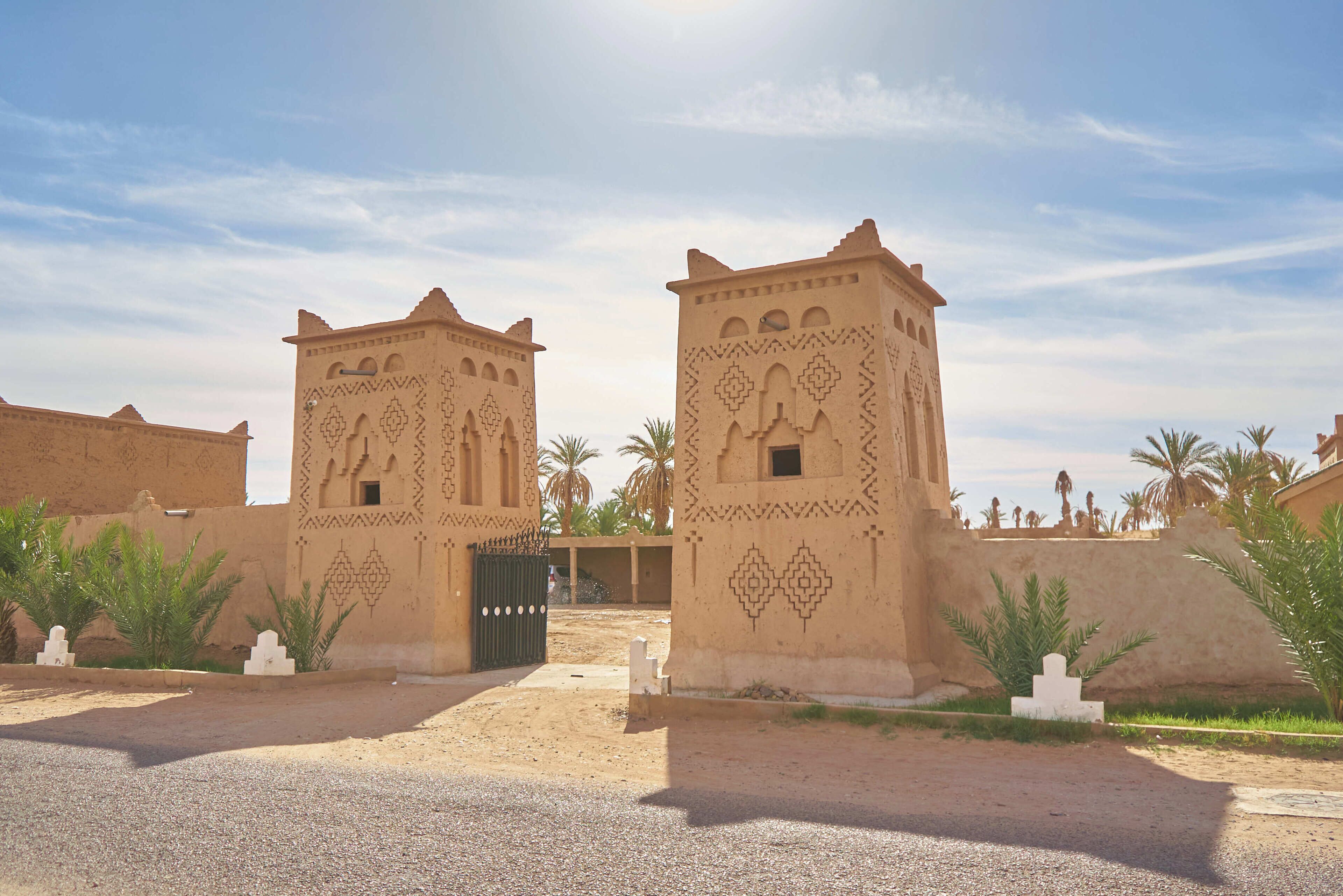 A traditional building with intricate geometric patterns and a gated entrance.